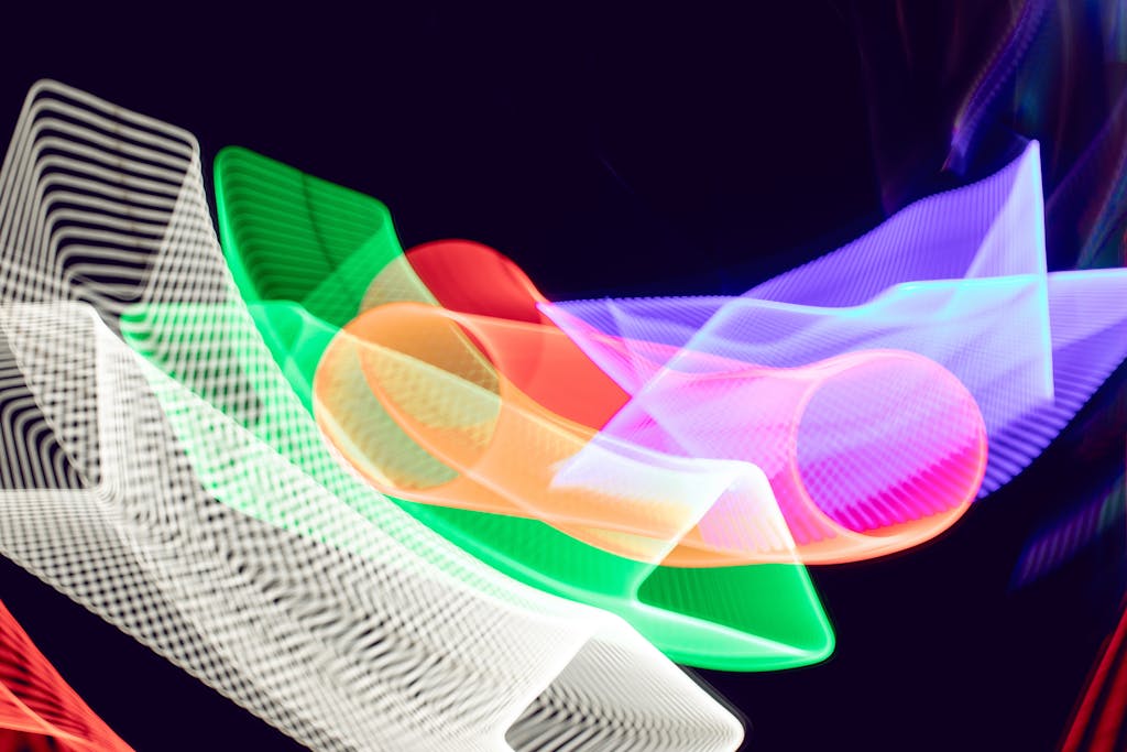 Colorful abstract light trails create a dynamic pattern on a dark background.